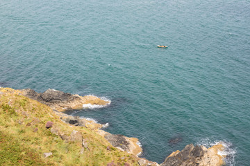 Two men and a dog in a small boat