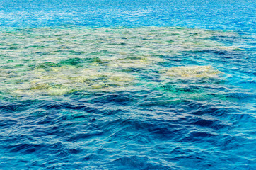 Colorful ripples of the water surface in the Red Sea overlooking the coral at the bottom