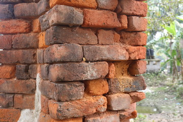 Old orange and red breakable brick arch wall with pattern.
