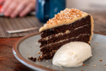 Close up of chocolate cake with small scoop of vanilla ice cream