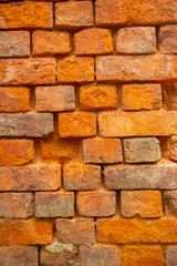 Old orange and red breakable brick arch wall with pattern.