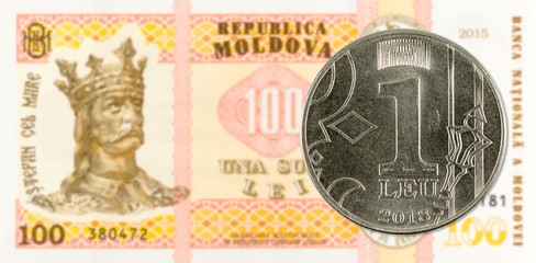 1 moldovan leu coin against 100 moldovan banknote indicating growing economics with copyspace