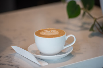 Delicious latte in coffee mug with perfectly executed foam latte art