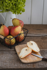 Fresh cutted pears in the basket on the wooden background