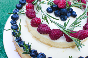 Delicious wedding cake with blueberry and raspberry