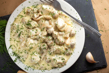 Chicken meat with mushrooms, cream and chopped fresh green dill