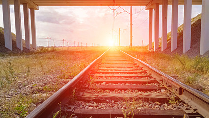 Railway tracks on the background of a bright flash of a nuclear explosion.