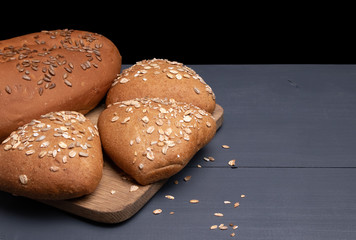 board with three buns and bread