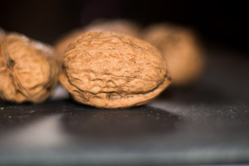 stacked walnuts with black background