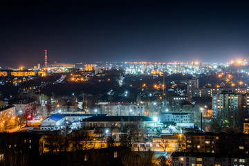 Naklejka premium City lights at night. Bright orange-blue lighting of the town.