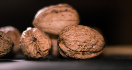 stacked walnuts with black background