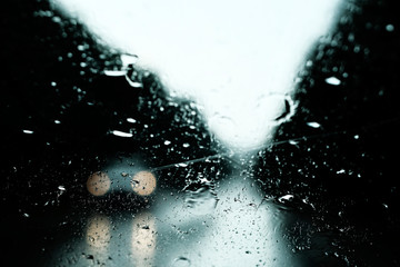 Misted glass with light in the middle and drops against a dark background