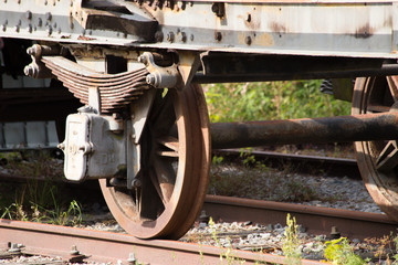 Fototapeta na wymiar Various rusted wagons and train on the tracks