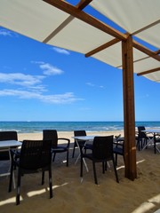 bar terrace with awning on the sand of the beach in Alicante Spain