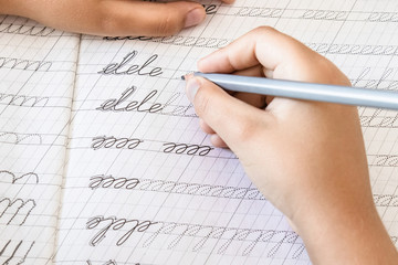 Schoolboy writing close-up. Pencil in the hand of children.