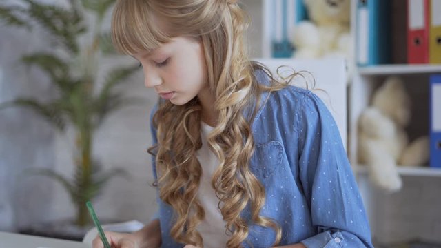 little cute girl doing homework in her room. children 9-12 years old. 4K