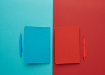 notebook on a red and blue background, back to school, student accessories, free space for an inscription, lay flat