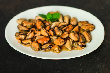 mussels in oil (delicious seafood) portion serving. top food background. copy space