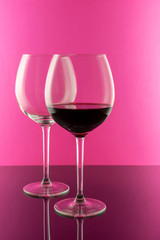 Red wine in Elegant glasses isolated on pink background. Wine concept. 