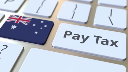 PAY TAX text and flag of Australia on the buttons on the computer keyboard. Taxation related conceptual 3D animation