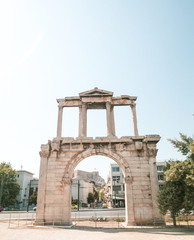 Fototapeta na wymiar Arch of Hadrian or Hadrian's Gate monument with the Parthenon in the background, Athens, Greek
