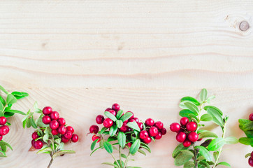 Fototapeta na wymiar Flat lay red ripe lingonberry, Cowberry, foxberry, on light wooden background. vegetation of North America, Scandinavia, Sweden, Baltic, Russia. wild berry, swamp, summer, August. copy space, mock up