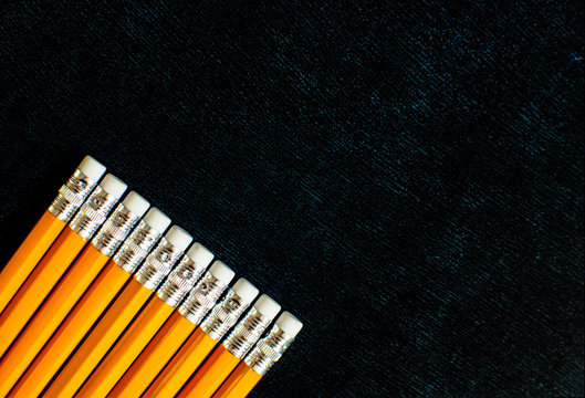 lots of pencils on black slate background