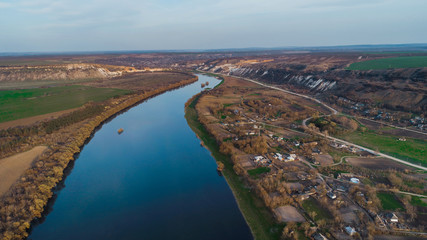 Beautiful shot of a river and a moldavian village to it's right.