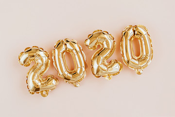 Foil balloons in the form of numbers 2020. New year celebration. Gold and silver Air Balloons. Holiday party decoration.