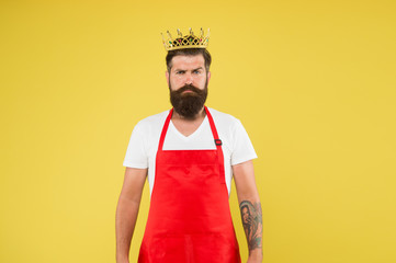 King of kitchen. Cook with beard and mustache yellow background. Man mature cook wear cooking apron and golden crown. Royal recipe. Ideas and tips. Chief cook and professional culinary. Cook food