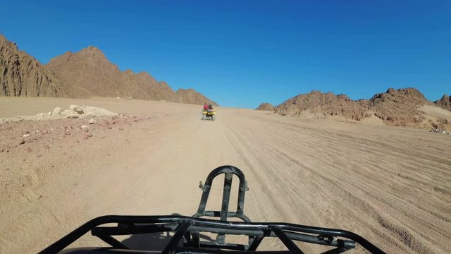 Riding a Quad in the Desert of Egypt. First-person view. Rides ATV bike.