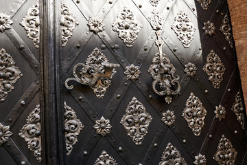 Detail in workman ship of a door leading into a church in Europe