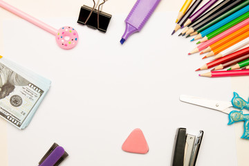 colored pencils, pen, eraser, stapler, marker, money euro dollars stack white background paper place copy top view back to school shopping for school