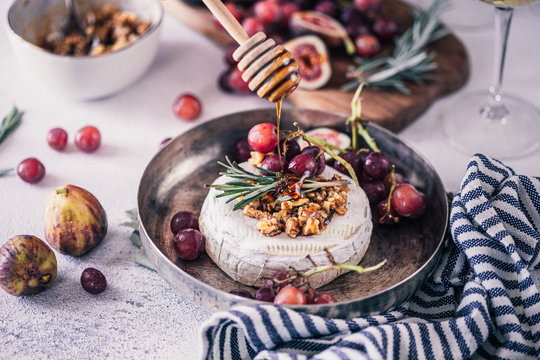 Fancy Baked Brie Cheese Platter With Honey And Walnuts, Fresh Rosemary. Red Grapes, Figs And White Wine