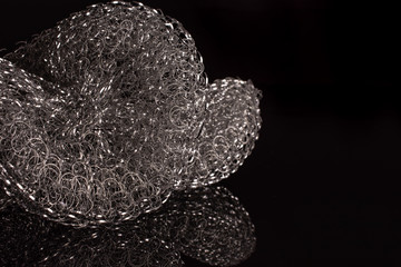 Closeup of two whole cleaning kitchen sponge isolated on black glass