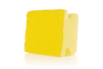 One whole yellow cleaning kitchen sponge letter shape isolated on white background