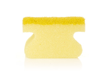 One whole yellow cleaning kitchen sponge letter shape isolated on white background