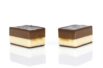 Group of two whole sweet mellow two coloured nougat piece isolated on white background