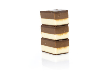 Group of three whole mellow two coloured nougat piece one on top of another isolated on white background