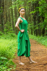 Woman in green dress, dancing in the Connecticut woods.