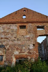 The building of the first manufactory stands on the outskirts of the village in the field.The building is red brick and stone. Ancient building in Belarus. Sights of Belarus.Sights of the Brest region