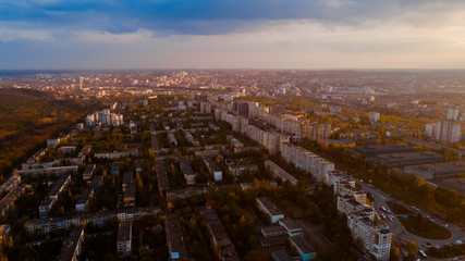 Aerial view of a beautiful city located at the edge of a forest, of a sky, during a majestic sunrise.