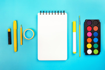 School supplies on yellow and pink background with copy space. Back to school concept.