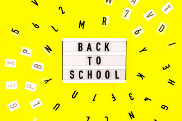 Back to school concept. Letters on yellow background.