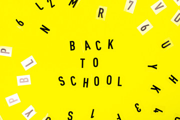 Back to school concept. Letters on yellow background.