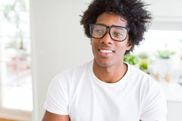 Fototapeta premium African American man wearing glasses smiling looking side and staring away thinking.