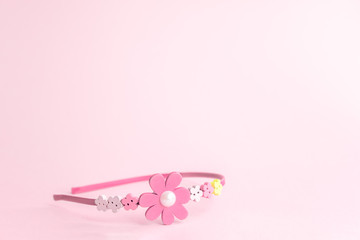 Pink wood headband for girls on pink background.