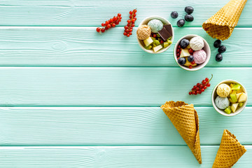 summer dessert with ice cream, chocolate and wineberry on mint green wooden backgroung top view mock up