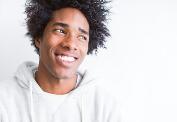 African American man over white isolated background smiling looking side and staring away thinking.