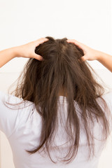 Fototapeta premium Woman suffering from an headache itching her head